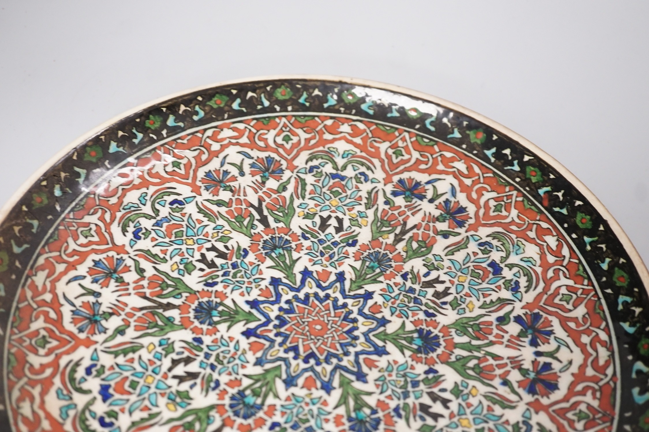 A Kütahya pottery dish, the back marked Azim Kütahya, diameter 31cm